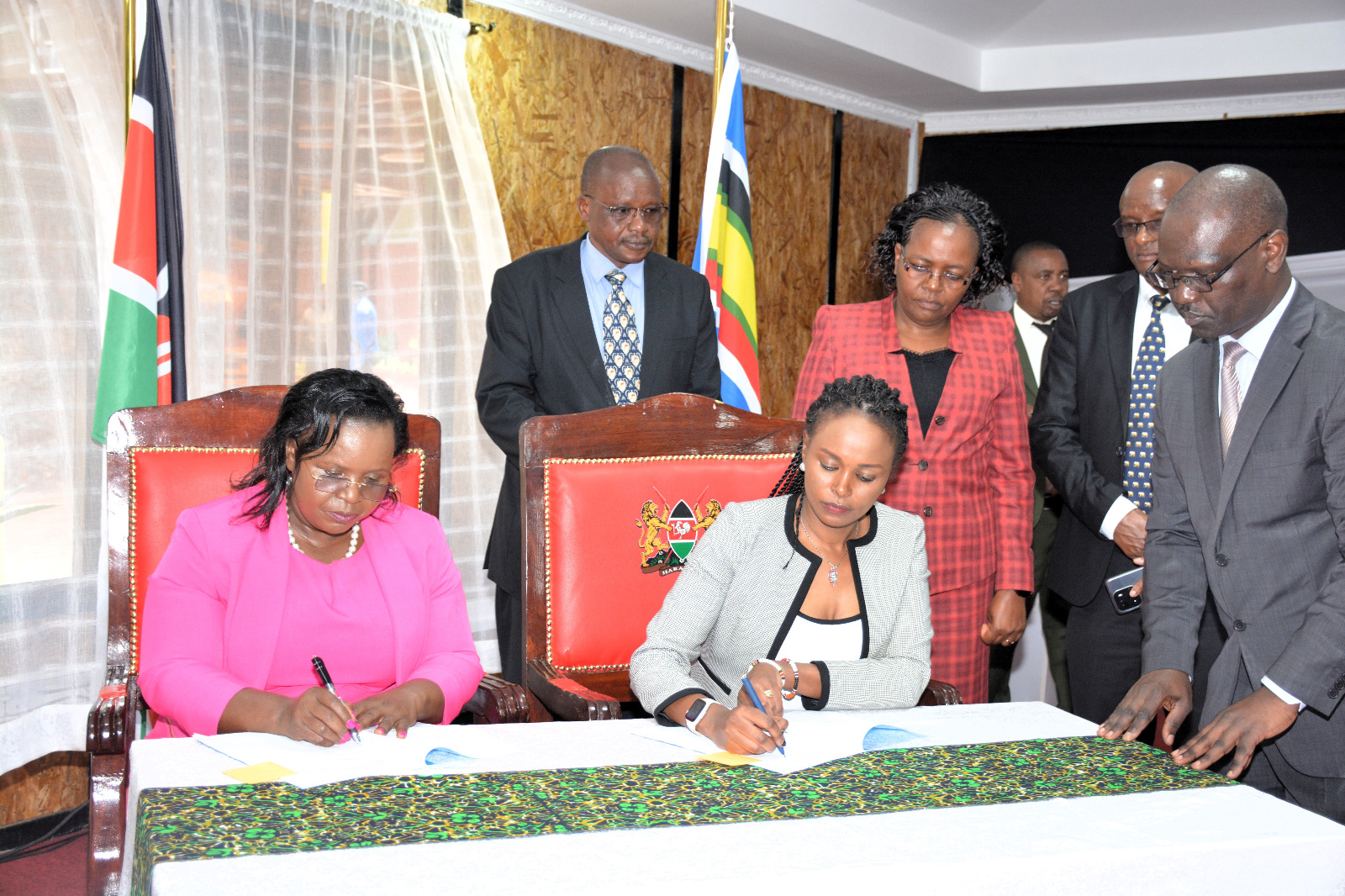 Cabinet Secretary for Tourism, Wildlife and Heritage Penina Malonza,(seated left and Principal Secretary for State Department for Wildlife, Ms Silvia Museiya Right) sign the 2023/2024 Performance Contract for the State department at the Bomas of Kenya witnessed by Heads of Department at the background.