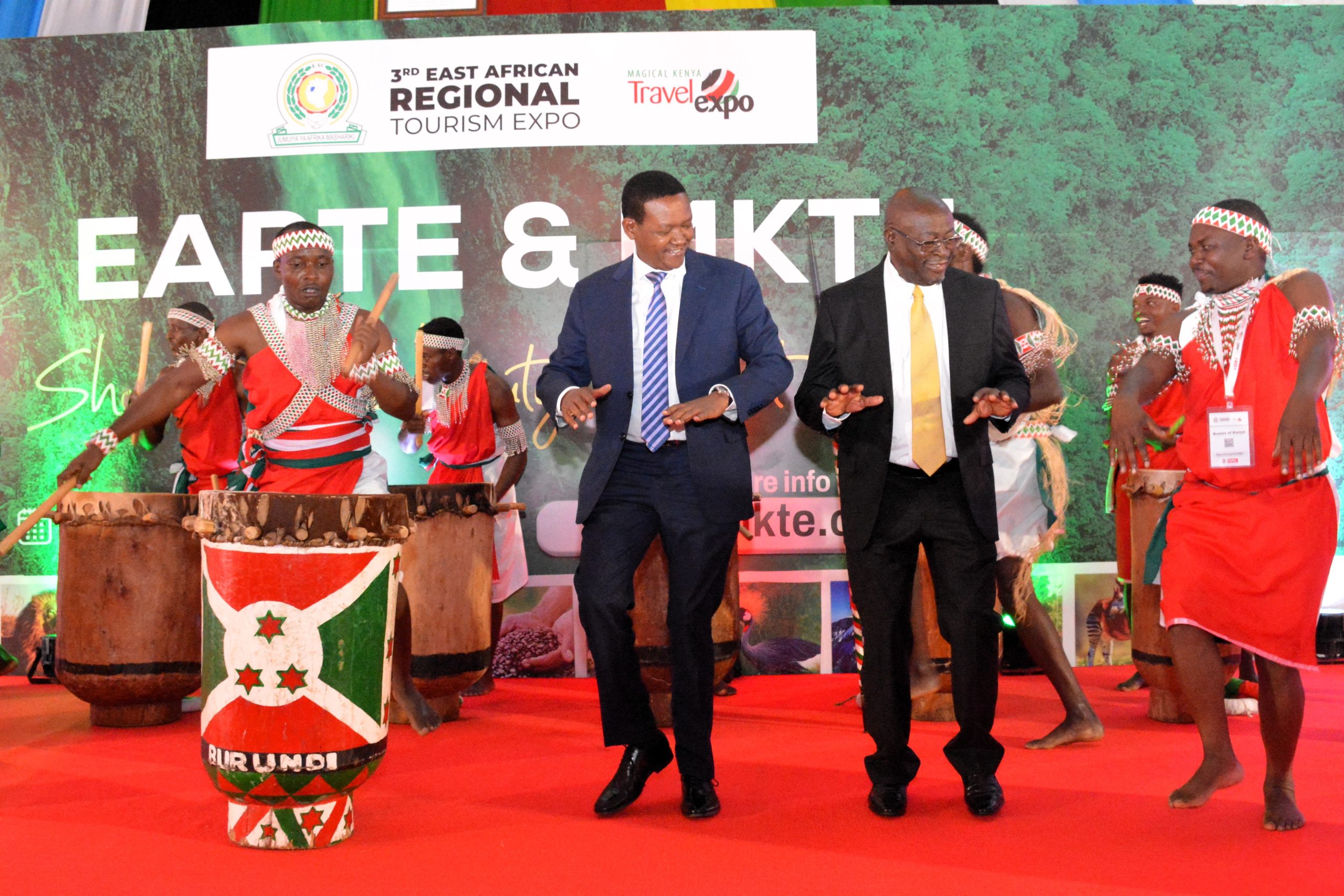 The Cabinet Secretary for Tourism and Wildlife-Kenya, Dr. Alfred Mutua (navy blue suit), is joined by South Africa's Deputy Minister for Tourism, Amos Fish (black suit), in dancing during the closing ceremony of the 3rd East African Regional Tourism Expo and the 12th Magical Kenya Travel Expo, today, at the Kenyatta International Convention Centre.