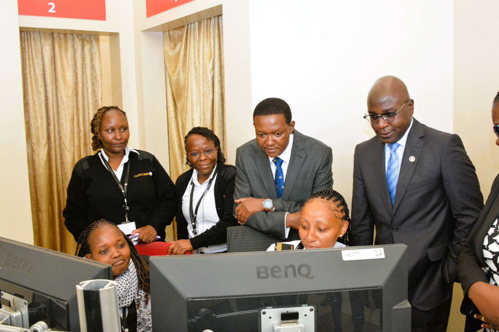The Cabinet Secretary, Dr. Aflred Mutua (leaning on chair), having a look at some of the luggages being screened.
