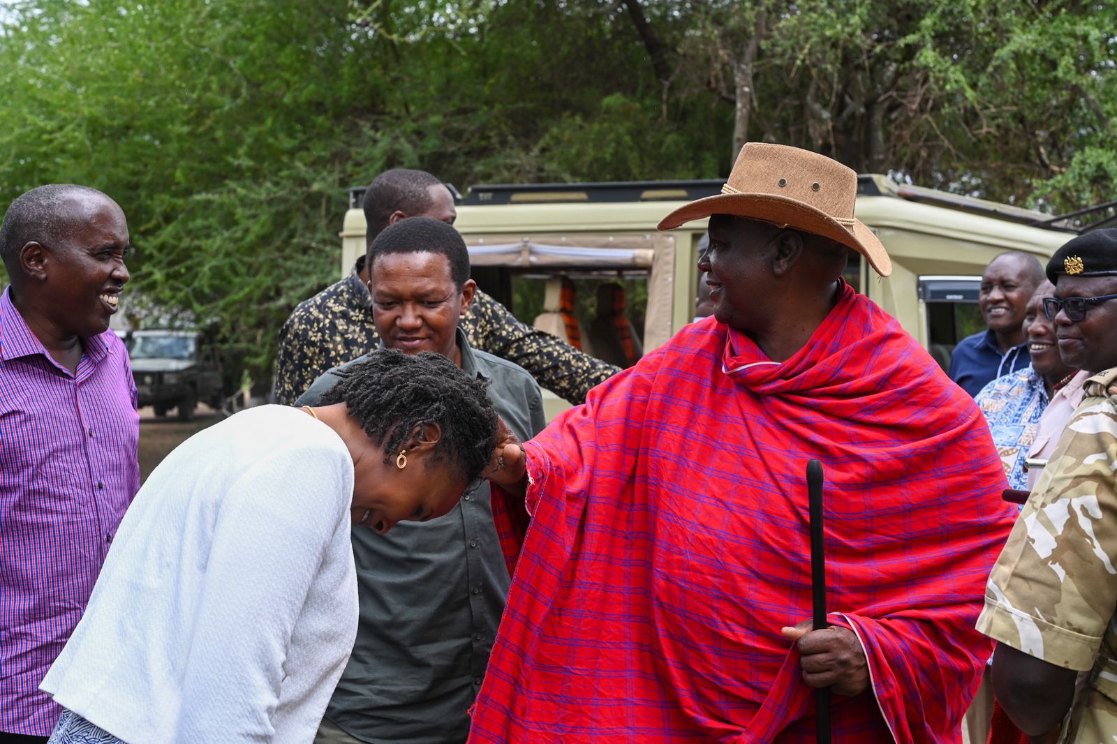 Principal Secretary Wildlife,Ms Silvia Museiya, displaying respect while being greeted by a Maasai elder.