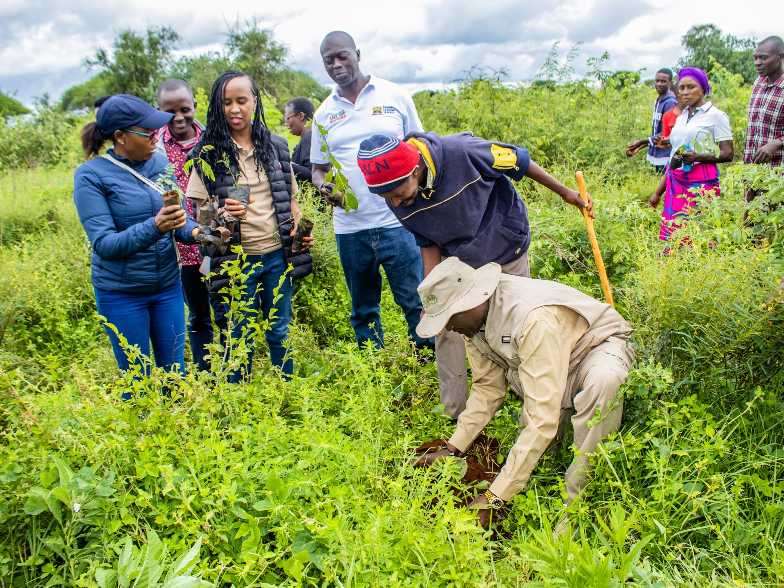 Ministry staff and personnel from associated parastatals in a tree-planting exercise within the Lumo Community Wildlife Conservancy