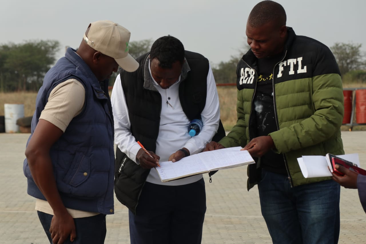 Pilots from KWS Airwing exchange notes before embarking on the Athi Kapiti Census