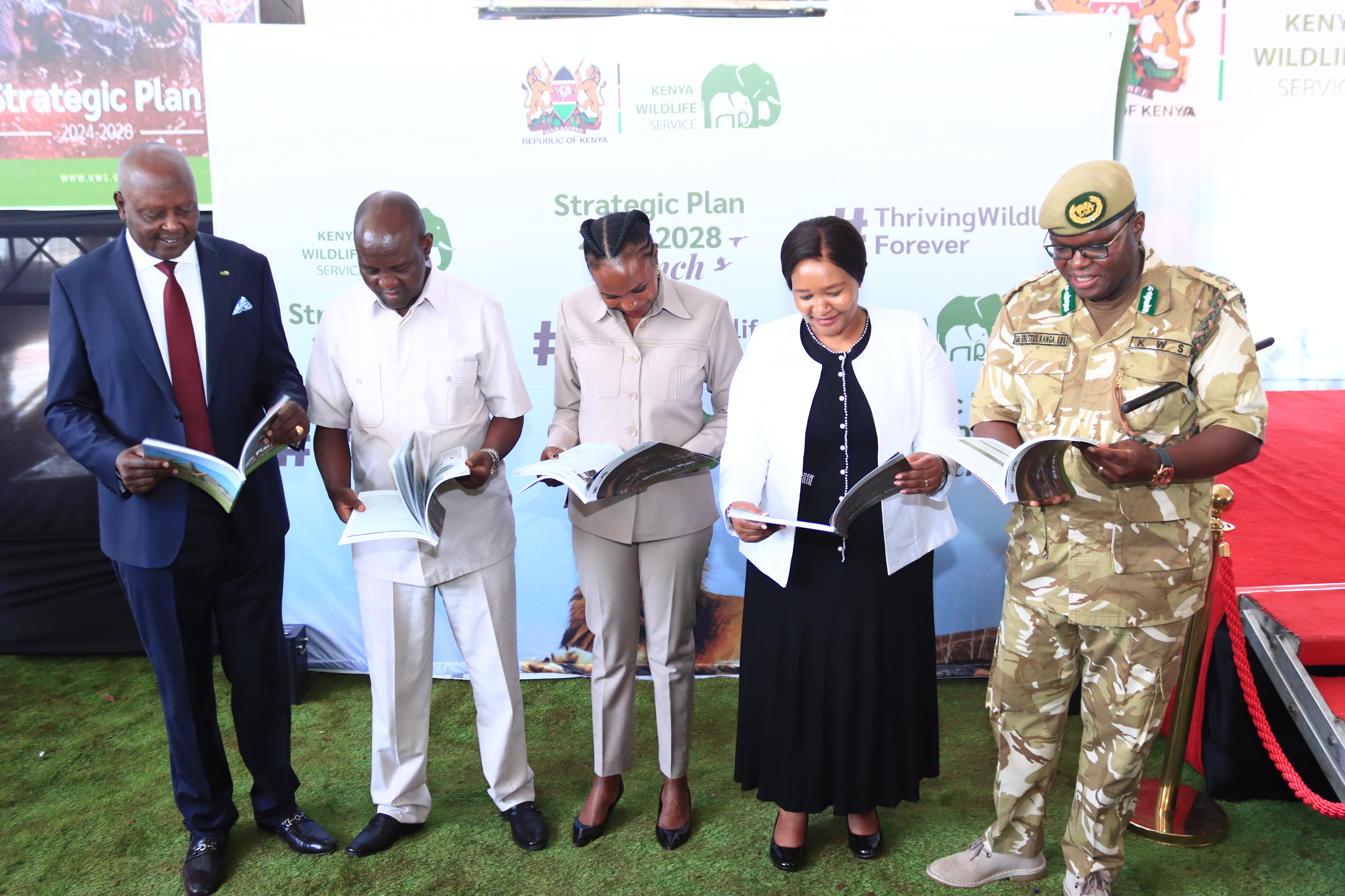 L-R KWS Chair Gen Koipaton,PS Tourism Mr Ololtuaa, PS Wildlife Ms Museiya, CS Tourism and Wildlife Hon Miano and DGKWS peruse through their copies of the launched KWS Strategic Plan 2024-2028